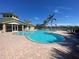 Community pool with a clubhouse and palm trees at 9367 Hawk Nest Ln, North Port, FL 34287