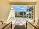 Screened porch with seating area and view of backyard at 9367 Hawk Nest Ln, North Port, FL 34287