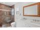 Modern bathroom with double vanity, large mirror, and walk-in shower at 939 Cronley Pl, Sarasota, FL 34237