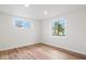 Spacious bedroom with wood-looking floors and two windows at 939 Cronley Pl, Sarasota, FL 34237