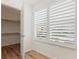 Walk-in closet with wood shelving and hardwood floors at 939 Cronley Pl, Sarasota, FL 34237