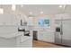 Modern kitchen featuring white shaker cabinets, quartz countertops, and stainless steel appliances at 939 Cronley Pl, Sarasota, FL 34237