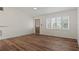 Living room with wood-look floors, shutters, and an updated front door at 939 Cronley Pl, Sarasota, FL 34237