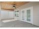 Covered patio with white french doors and ceiling fan at 939 Cronley Pl, Sarasota, FL 34237