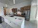 Modern kitchen with wood cabinets, stainless steel appliances, and a large island at 9493 St Paul Dr, Port Charlotte, FL 33981