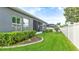 Landscaped backyard with screened patio, lush lawn, and privacy fence at 1115 116Th E St, Bradenton, FL 34212