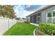 Landscaped backyard with a privacy fence and screened patio at 1115 116Th E St, Bradenton, FL 34212