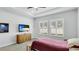 Bright bedroom with a dresser, TV, and plantation shutters at 1115 116Th E St, Bradenton, FL 34212