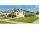 One-story house with gray siding, beige garage door, and well-maintained landscaping at 1115 116Th E St, Bradenton, FL 34212
