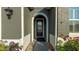 Elegant arched entryway with a dark brown door and stained-glass accents at 1115 116Th E St, Bradenton, FL 34212