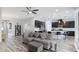 Open living room and kitchen with modern appliances and wood-look tile floors at 1115 116Th E St, Bradenton, FL 34212