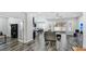 Open living area with wood-look tile floors, a sectional sofa, and access to a patio at 1115 116Th E St, Bradenton, FL 34212