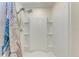 Shower with built-in shelving and patterned curtain at 12226 Kingsley Trl, Parrish, FL 34219