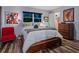 Bright bedroom with wood floors, comfortable bed, and modern art at 1330 N Lockwood Ridge Rd, Sarasota, FL 34237