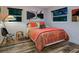 Charming bedroom featuring a patterned comforter and large windows at 1330 N Lockwood Ridge Rd, Sarasota, FL 34237