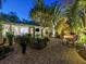 Lush courtyard with brick pavers, wicker furniture, and lighting at 1330 N Lockwood Ridge Rd, Sarasota, FL 34237