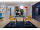 Small contemporary dining area with glass table and yellow chairs at 1330 N Lockwood Ridge Rd, Sarasota, FL 34237