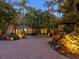 Landscaped front yard with tropical plants and a brick driveway leading to the house entrance at 1330 N Lockwood Ridge Rd, Sarasota, FL 34237