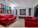 Relaxing living room with red leather furniture and large windows at 1330 N Lockwood Ridge Rd, Sarasota, FL 34237