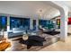 Spacious living room with large windows, hardwood floors and mid-century furniture at 1330 N Lockwood Ridge Rd, Sarasota, FL 34237