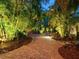 Brick pathway lit at night, leads through lush tropical landscaping at 1330 N Lockwood Ridge Rd, Sarasota, FL 34237