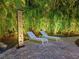Relaxing patio oasis with lounge chairs and artistic lighting at night at 1330 N Lockwood Ridge Rd, Sarasota, FL 34237
