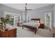 Main bedroom with wood platform bed, ceiling fan, and access to balcony at 1444 Landings Cir # 72, Sarasota, FL 34231