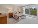 Guest bedroom with sliding door to balcony and wood dresser at 1444 Landings Cir # 72, Sarasota, FL 34231