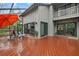 Large deck with multiple sliding glass doors and lush landscaping at 1444 Landings Cir # 72, Sarasota, FL 34231