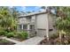Two-story home with attached garage and walkway leading to the entrance at 1444 Landings Cir # 72, Sarasota, FL 34231