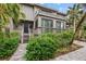 Two-story home with gray siding, multiple balconies, and lush landscaping at 1444 Landings Cir # 72, Sarasota, FL 34231