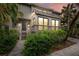 Two-story home with gray siding, a walkway, and landscaping at 1444 Landings Cir # 72, Sarasota, FL 34231