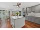 Modern kitchen with gray cabinets, white island, and hardwood floors at 1444 Landings Cir # 72, Sarasota, FL 34231