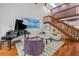 Open living room with hardwood floors, grand piano, and staircase at 1444 Landings Cir # 72, Sarasota, FL 34231