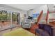 Spacious living room with hardwood floors, grand piano, and access to deck at 1444 Landings Cir # 72, Sarasota, FL 34231