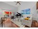 Living room with hardwood floors, grand piano, and access to deck at 1444 Landings Cir # 72, Sarasota, FL 34231
