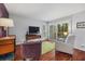 Living room with hardwood floors, comfy chairs, and access to deck at 1444 Landings Cir # 72, Sarasota, FL 34231