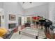 Bright living room with hardwood floors, grand piano, and fireplace at 1444 Landings Cir # 72, Sarasota, FL 34231