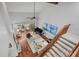 High-ceiling living room with hardwood floors, a piano, and access to balcony at 1444 Landings Cir # 72, Sarasota, FL 34231
