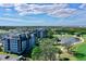 Exterior view of two buildings surrounded by well-manicured greenery and a beautiful lake at 14820 Rue De Bayonne # 308, Clearwater, FL 33762