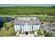 An aerial view of the building, surrounded by a golf course, grass and foliage at 14820 Rue De Bayonne # 308, Clearwater, FL 33762
