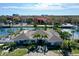 An aerial view of a community clubhouse surrounded by lush landscaping and serene water features at 14820 Rue De Bayonne # 308, Clearwater, FL 33762