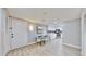 Bright dining area with modern decor, light wood-look flooring, and a view of the updated kitchen at 14820 Rue De Bayonne # 308, Clearwater, FL 33762