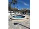 A refreshing hot tub with tiled patio and furniture to lounge around at 14820 Rue De Bayonne # 308, Clearwater, FL 33762