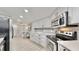 Stylish kitchen with stainless steel appliances, granite countertops, and light wood-look flooring at 14820 Rue De Bayonne # 308, Clearwater, FL 33762