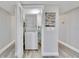 Functional laundry area with stacked washer and dryer, and a neutral color palette at 14820 Rue De Bayonne # 308, Clearwater, FL 33762