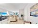 Bright living room offers comfortable seating, modern decor, and access to a balcony with scenic views at 14820 Rue De Bayonne # 308, Clearwater, FL 33762
