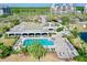 Aerial view of a community pool with many chairs available and a jacuzzi at 14820 Rue De Bayonne # 308, Clearwater, FL 33762