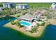 Beautiful aerial of the pool with lush landscaping and a view of the lake at 14820 Rue De Bayonne # 308, Clearwater, FL 33762