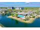 Stunning aerial view of a community pool surrounded by lush landscaping and waterways at 14820 Rue De Bayonne # 308, Clearwater, FL 33762